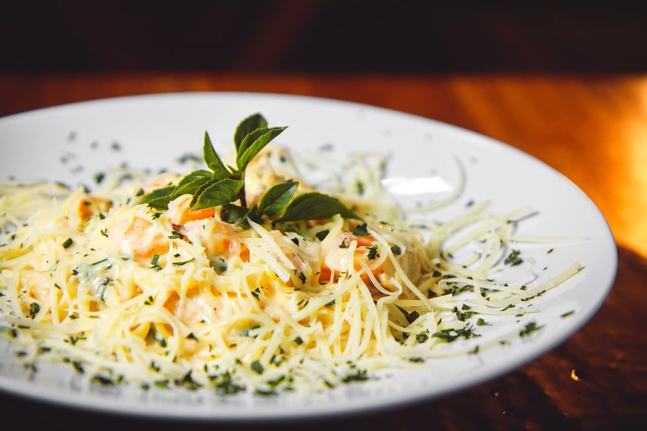 Plated pasta dish garnished with fresh basil